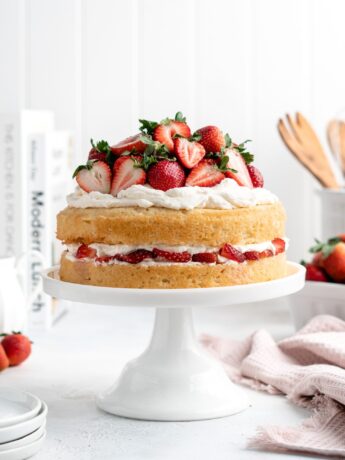 Light and fluffy sponge cake layers are sandwiched over a layer of mascarpone whipped cream and macerated strawberries in this Strawberry Shortcake Layer Cake