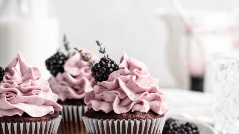 quick and easy chocolate cupcakes are topped with a creamy lavender blackberry buttercream frosting