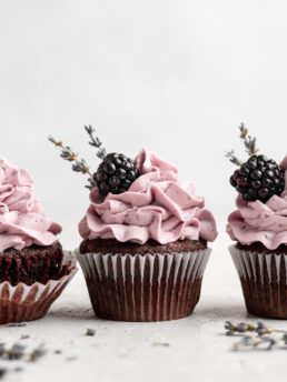 quick and easy chocolate cupcakes are topped with a creamy lavender blackberry buttercream frosting