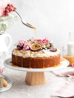 Moist, fluffy Triple Coconut Cake is topped with a creamy passion fruit caramel sauce