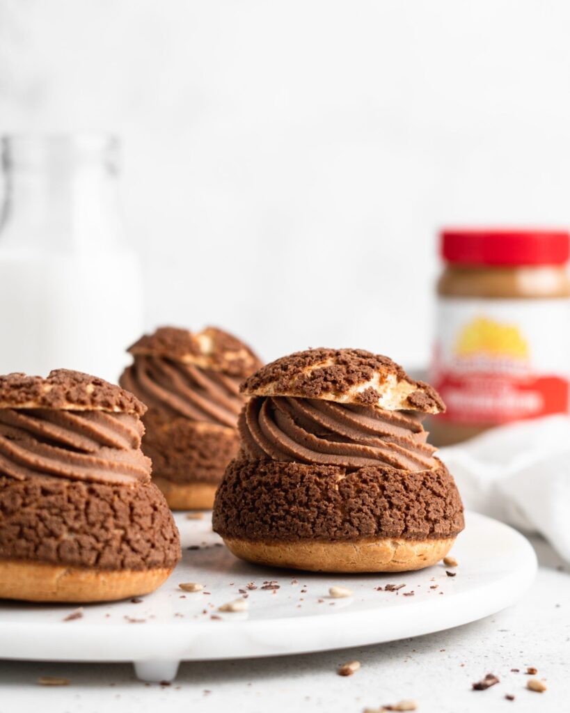 Cream puffs topped with a chocolate craquelin, filled with a creamy SunButter Milk Chocolate whipped ganache filling