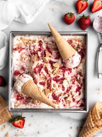 No Churn Strawberry Cheesecake Ice Cream in a square pan with cones