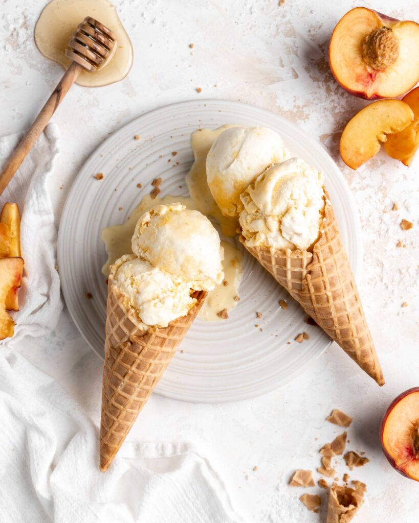 Homemade no churn salted honey and peach ice cream in 2 cones