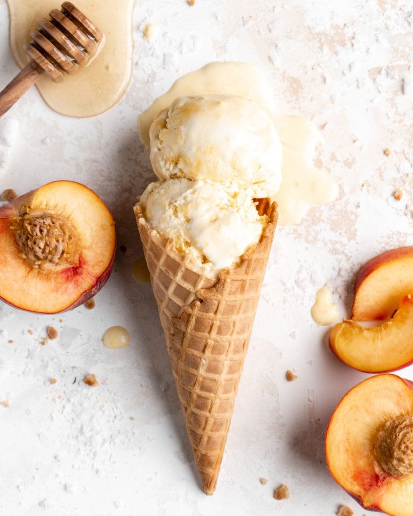 Homemade no churn salted honey and peach ice cream in a cone