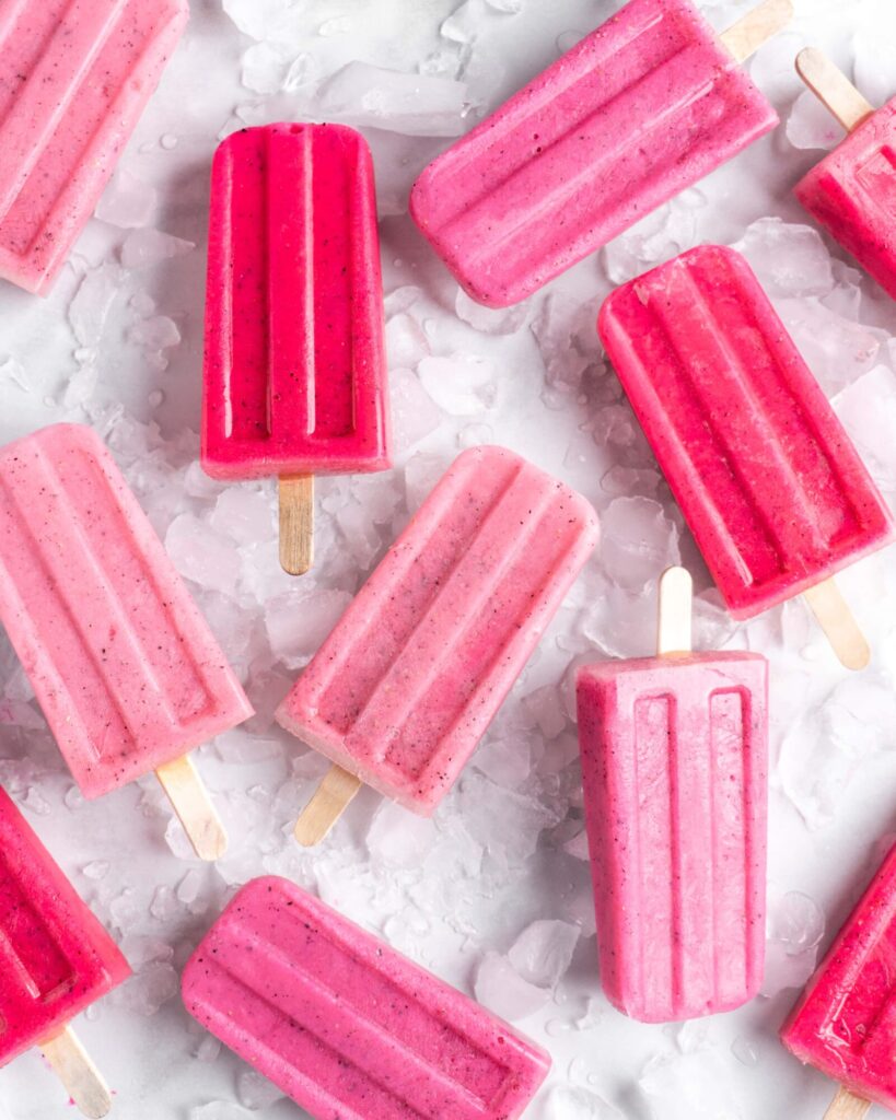 Bright pink popsicles are made with guava juice, dragon fruit (pitaya), greek yogurt, and agave.