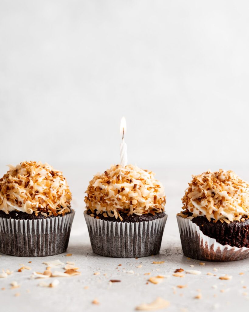 Chocolate coconut cupcakes are topped with a creamy coconut frosting and toasted coconut