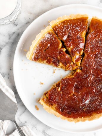 Velvety pumpkin tart is topped with a creme brulee topping and baked in a buttery shortbread crust