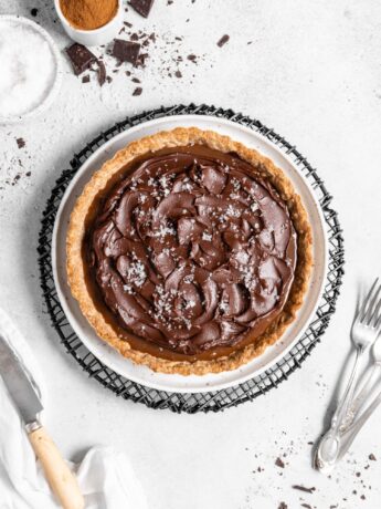 This Chai Salted Caramel Chocolate Tart features a spicy chai infused crust, chai salted caramel filling, and a creamy chocolate ganache topping