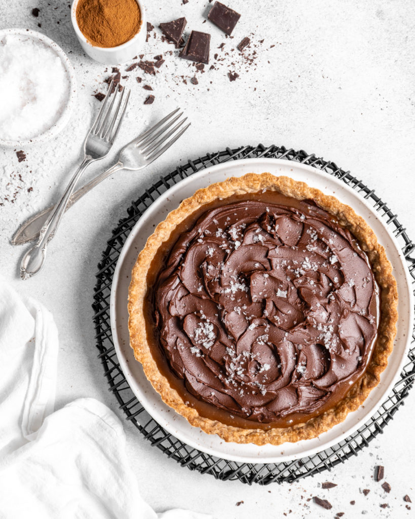 This Chai Salted Caramel Chocolate Tart features a spicy chai infused crust, chai salted caramel filling, and a creamy chocolate ganache topping