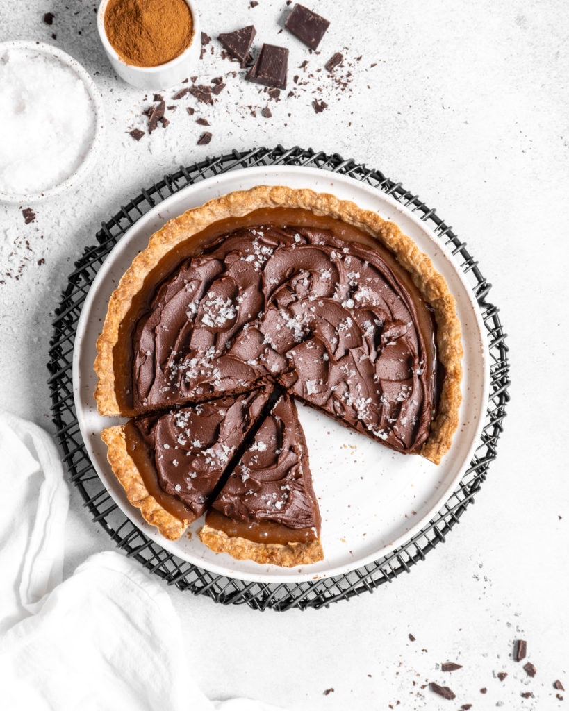 This Chai Salted Caramel Chocolate Tart features a spicy chai infused crust, chai salted caramel filling, and a creamy chocolate ganache topping
