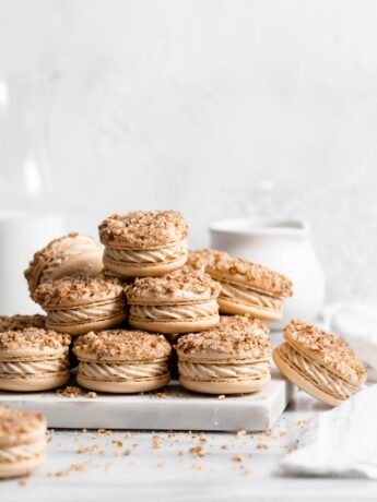 Maple pecan macarons using swiss method, filled with rich maple flavor, the macarons also have a maple buttercream that is speckled with little pecan bits, and a pecan crusted top