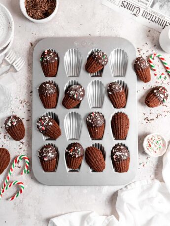 Chocolate peppermint madeleines dipped in chocolate and sprinkled with candy canes