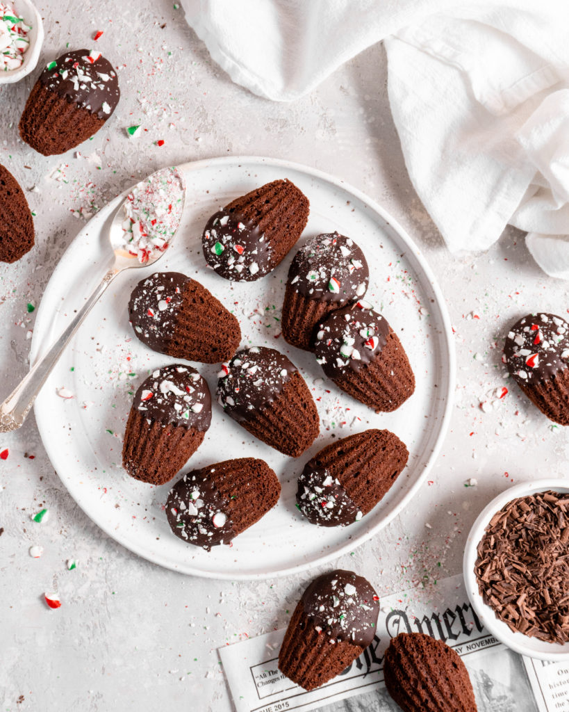 Chocolate peppermint madeleines dipped in chocolate and sprinkled with candy canes