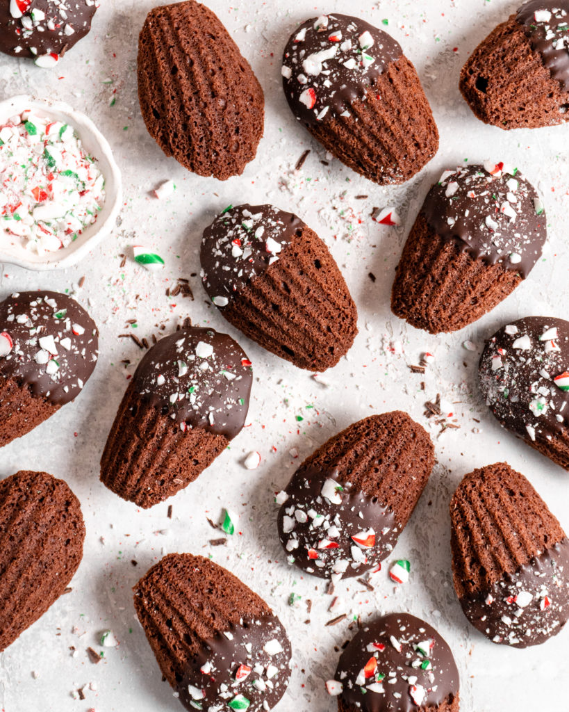 Chocolate peppermint madeleines dipped in chocolate and sprinkled with candy canes