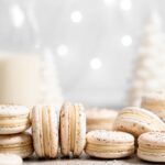 eggnog macarons filled with eggnog white chocolate ganache in a christmas scene