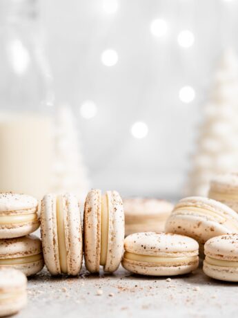 eggnog macarons filled with eggnog white chocolate ganache in a christmas scene