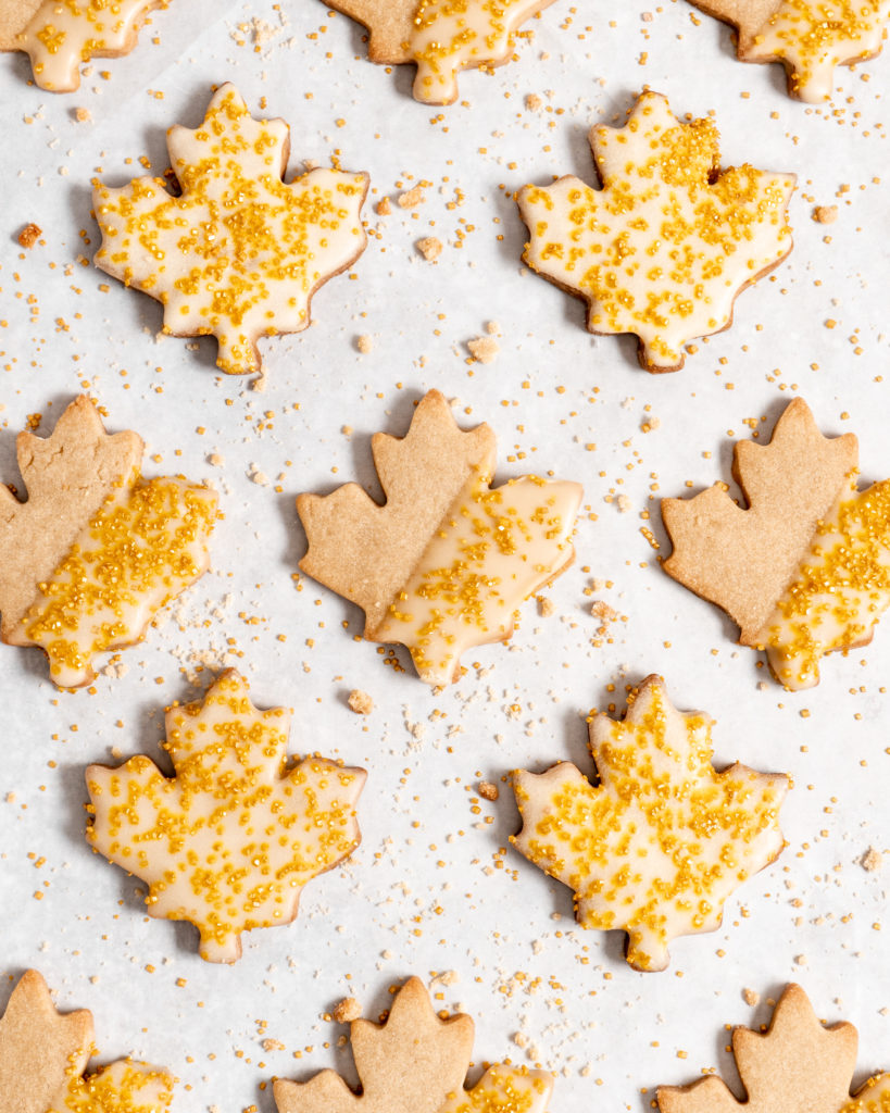 maple sugar cookies with maple butter glaze and decorated with golden sugar sprinkles