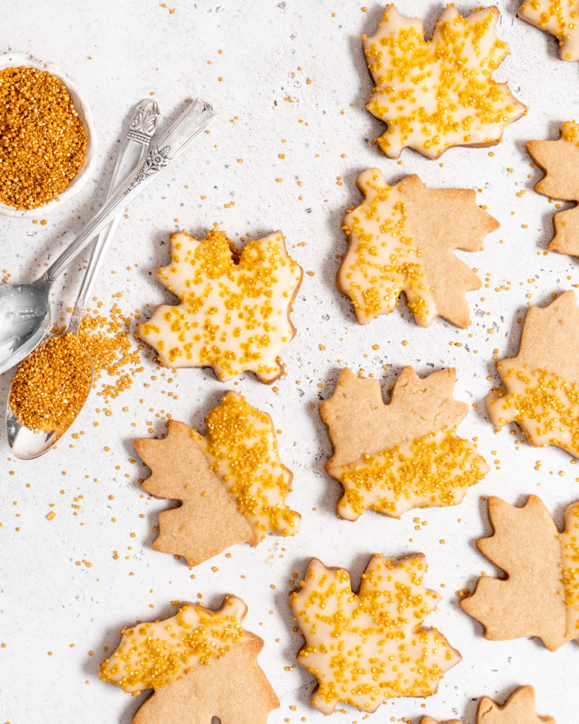 maple sugar cookies with maple butter glaze and decorated with golden sugar sprinkles