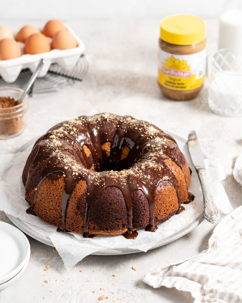 SunButter and chocolate marble bundt cake topped with chocolate ganache