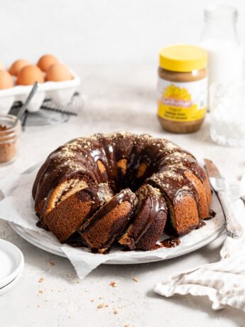 SunButter and chocolate marble bundt cake topped with chocolate ganache