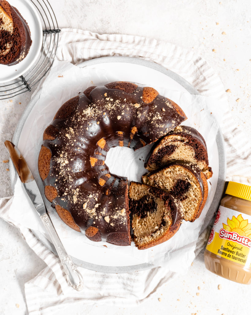 SunButter and chocolate marble bundt cake topped with chocolate ganache