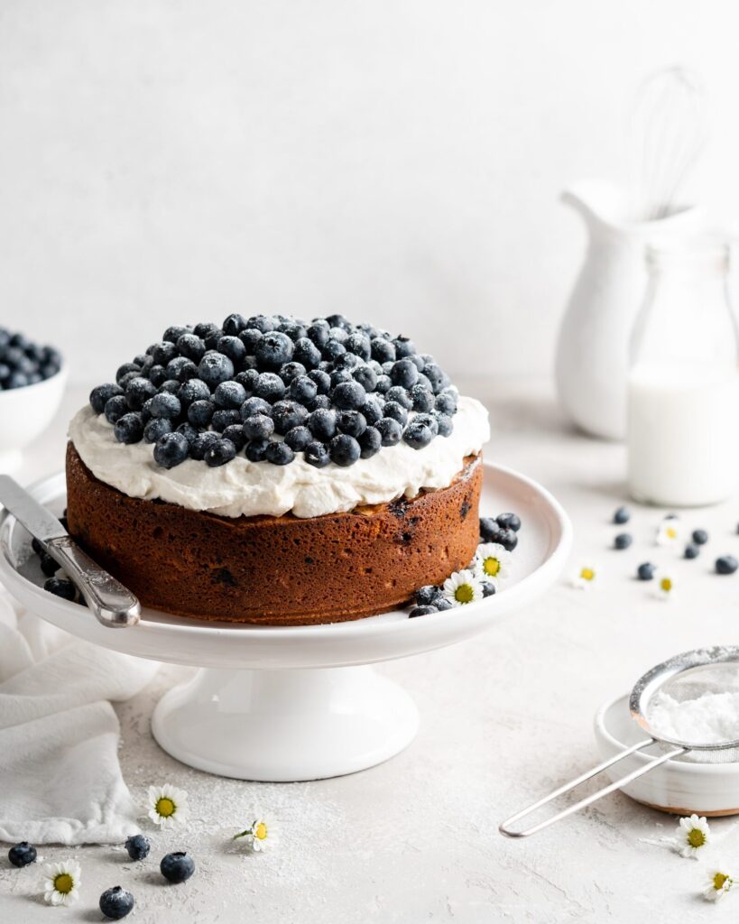 Single layer blueberry elderflower cake is topped with creamy mascarpone whipped cream and a ton of fresh, plump blueberries