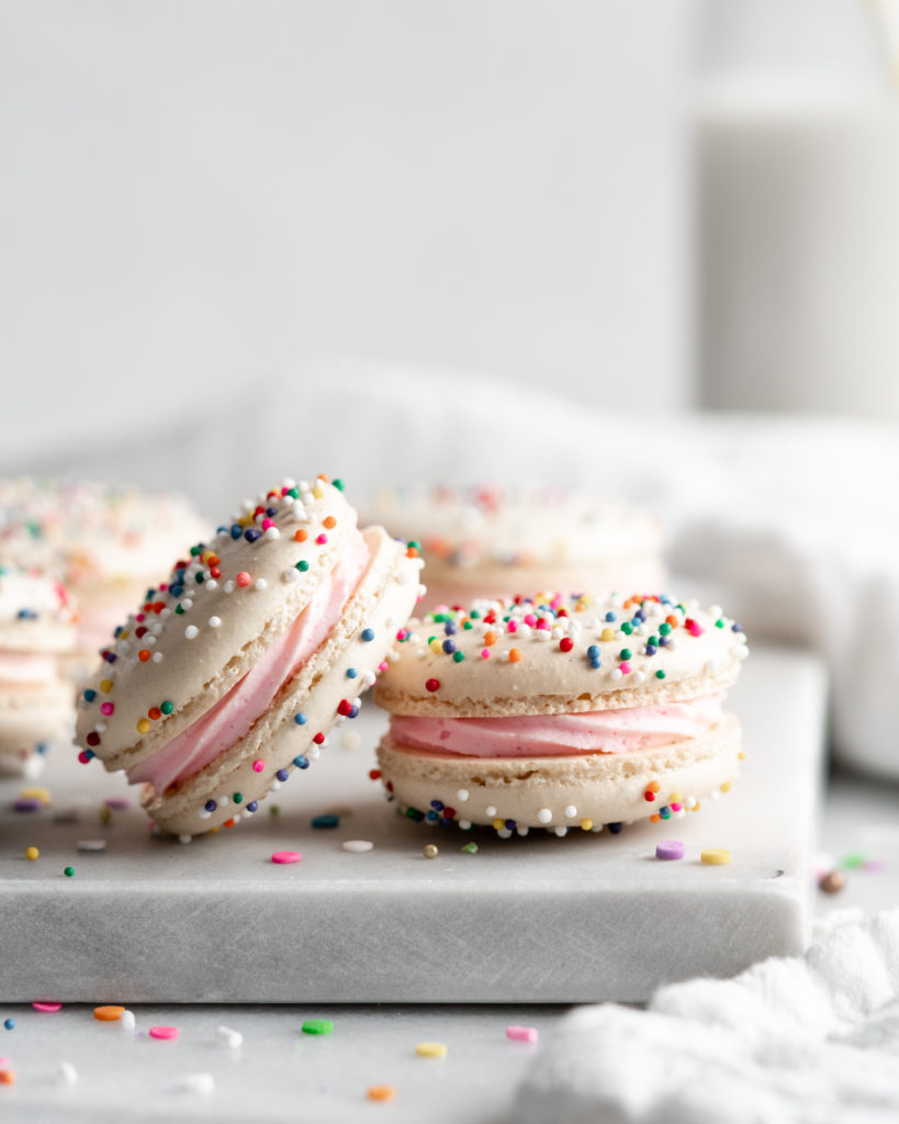 White Birthday Cake Macarons covered in rainbow sprinkles