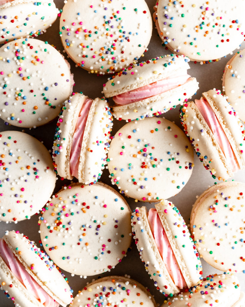 White Birthday Cake Macarons covered in rainbow sprinkles