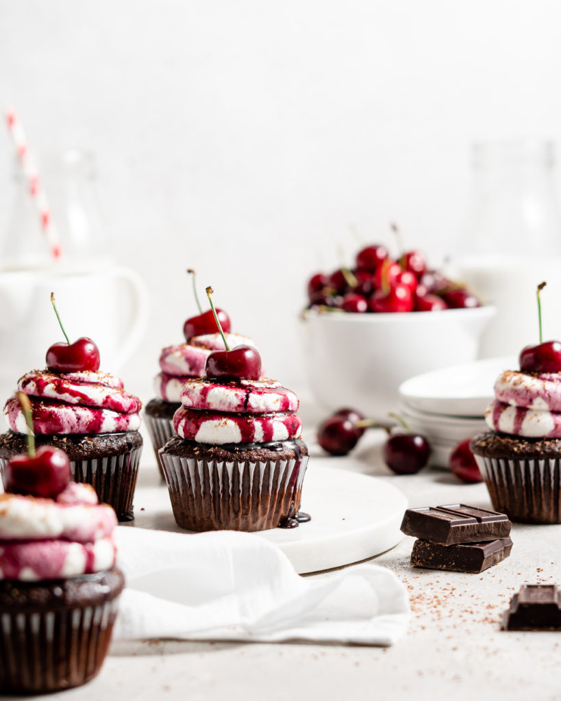 Black forest cupcake with cherry compote filling and whipped cream topping with cherry on top