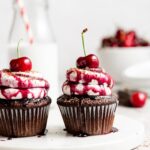 Black forest cupcake with cherry pie filling and whipped cream topping with cherry on top
