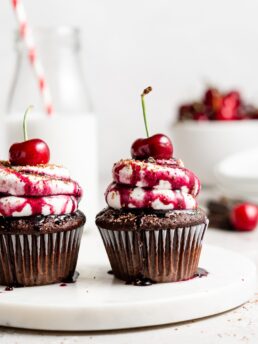 Black forest cupcake with cherry pie filling and whipped cream topping with cherry on top