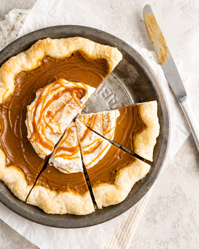 Pumpkin pie with whipped cream and salted caramel