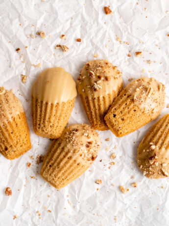 maple chai spiced madeleines dipped in a maple glaze and sprinkled with crushed pecans