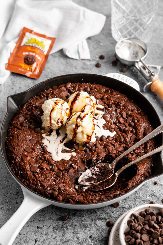 triple chocolate brownie skillet topped with vanilla ice cream