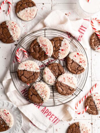 Crinkly fudgy chocolate peppermint brownie cookies dipped in white chocolate and sprinkled with crushed candy canes