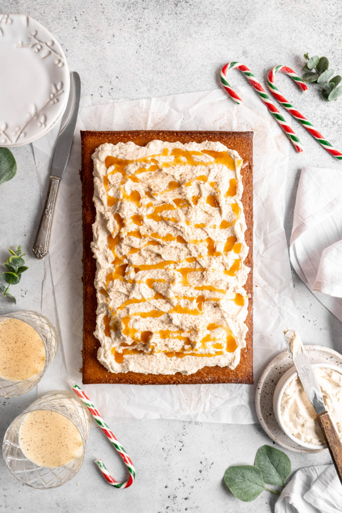 Bourbon Eggnog Sheet Cake with fluffy eggnog frosting, drizzled with caramel sauce