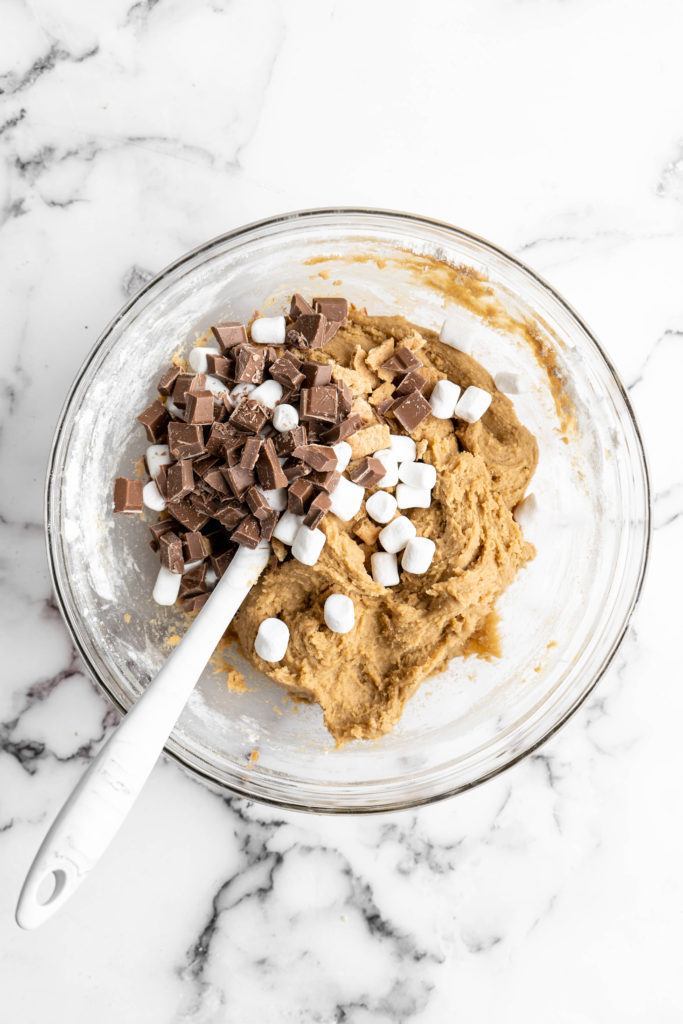 s'mores cookie batter with chocolate, marshmallows and graham crackers on top