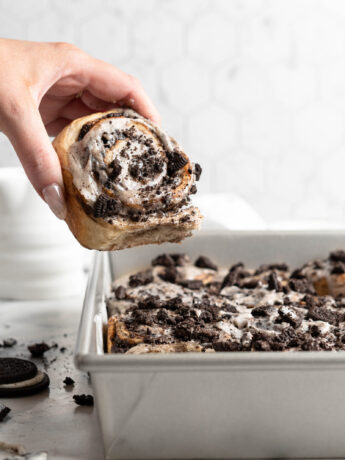 Oreo Cookies and cream cinnamon roll being pulled from pan