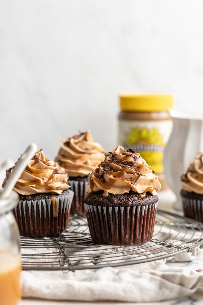 Snicker chocolate cupcakes filled with peanut free SunButter caramel sauce, topped with caramel buttercream, caramel sauce and chocolate shavings
