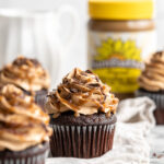 Snicker chocolate cupcakes filled with peanut free SunButter caramel sauce, topped with caramel buttercream, caramel sauce and chocolate shavings