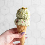 pistachio ice cream scoops in a cone
