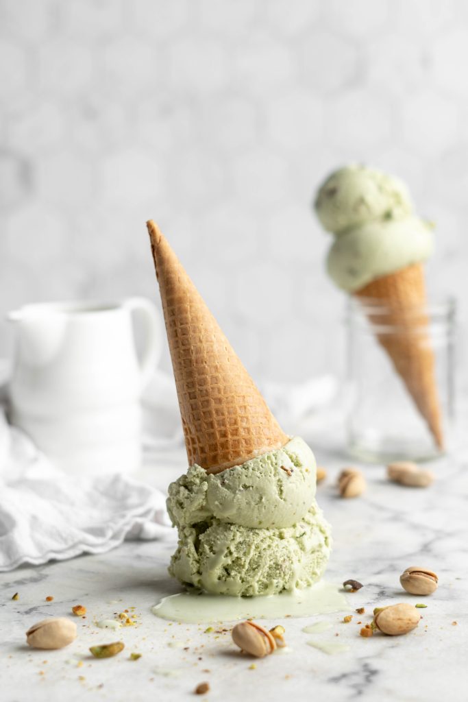 pistachio ice cream scoops in a cone upside down